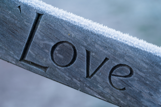 The word 'love' on a wooden post
