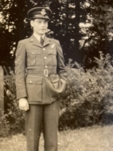 Norman Dawson in uniform standing in a garden (family photo)